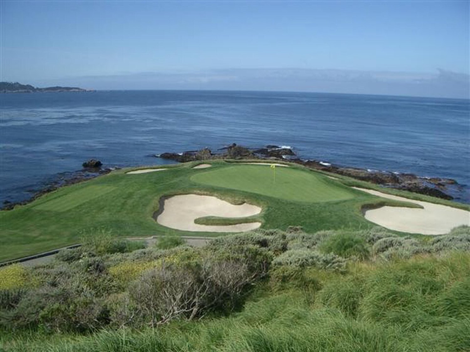 The cliffside seventh green at Pebble Beach Golf Links above the Pacific